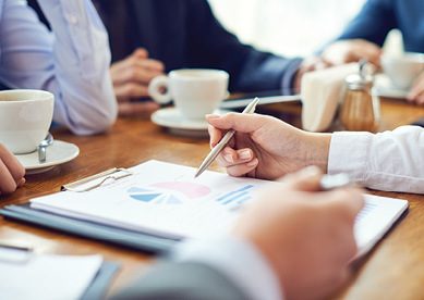 Close-up image of business associates reviewing charts