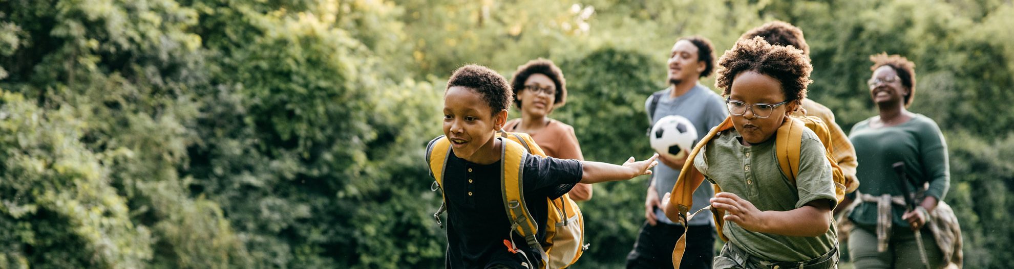 Family running in a field outside